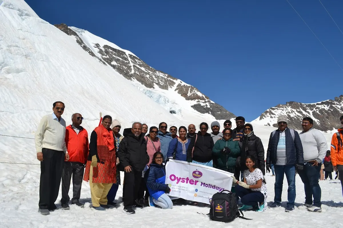Oyster Holidays group in the snow on a mountain tour