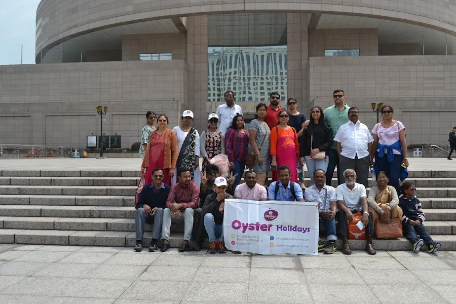 Oyster Holidays travellers holding the Oyster banner on a group tour