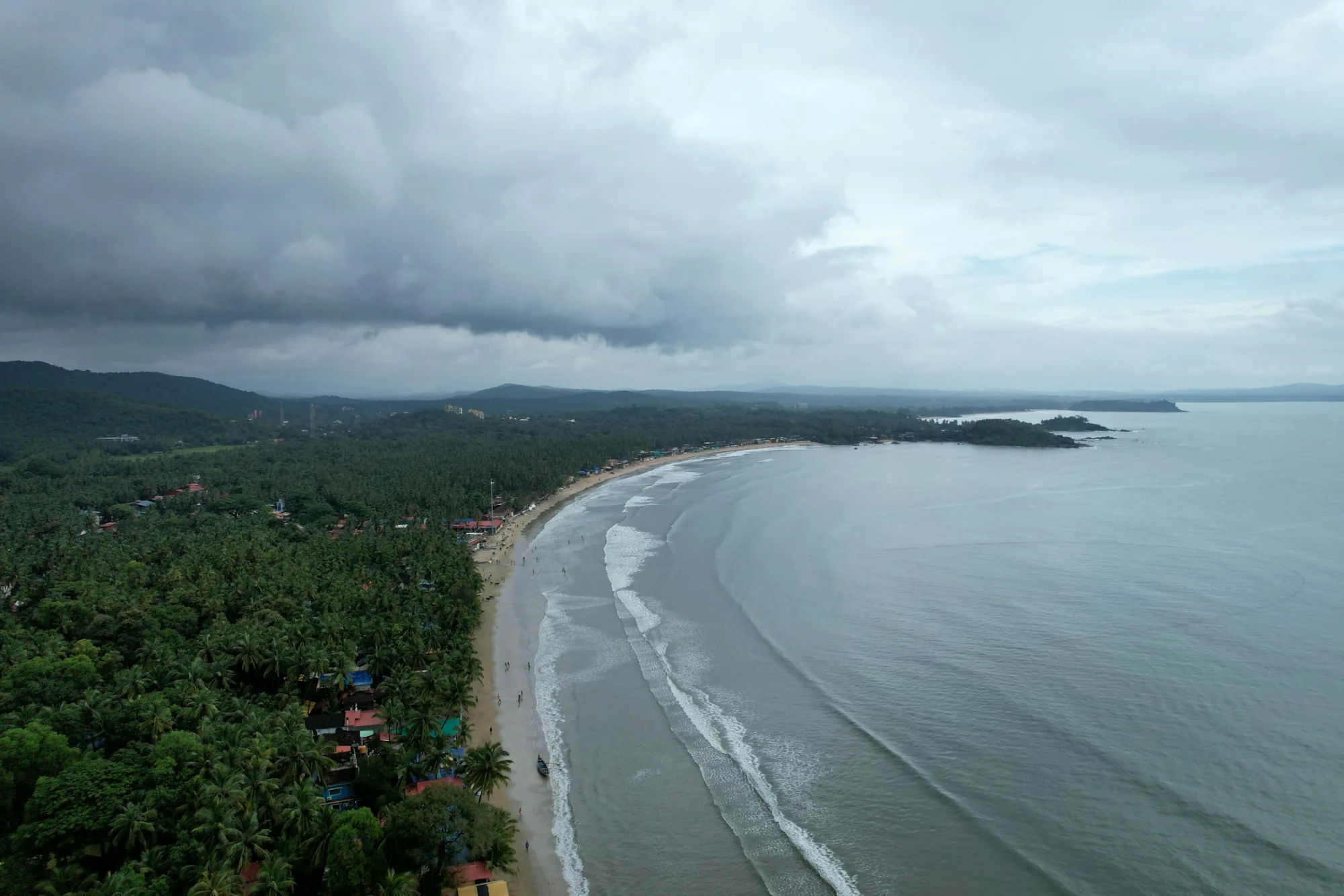 Aerial view of a long sandy beach along the Goa coastline