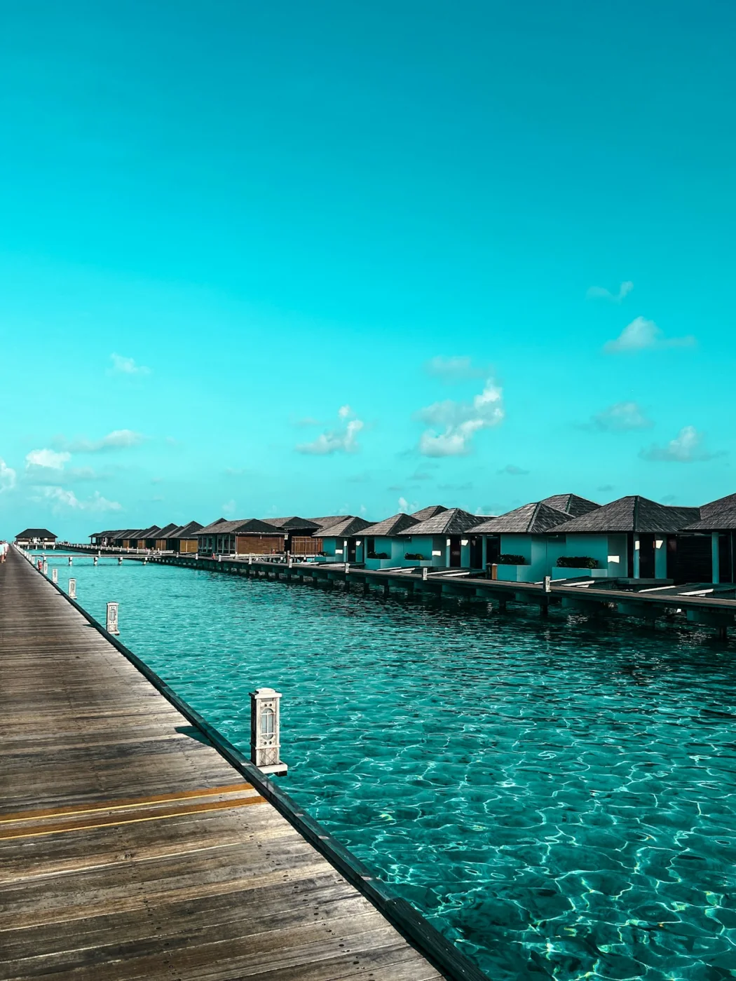 Overwater bungalows above the clear turquoise sea in the Maldives