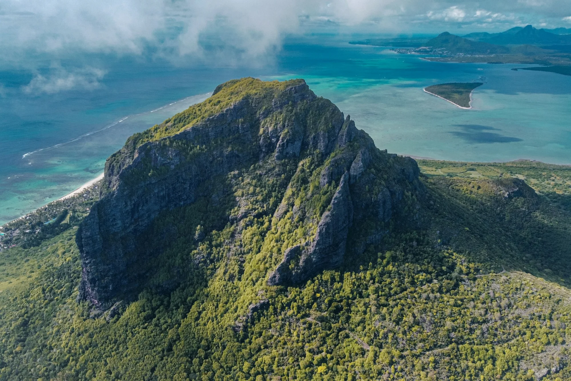 A lush green mountain rising on the coast of Mauritius