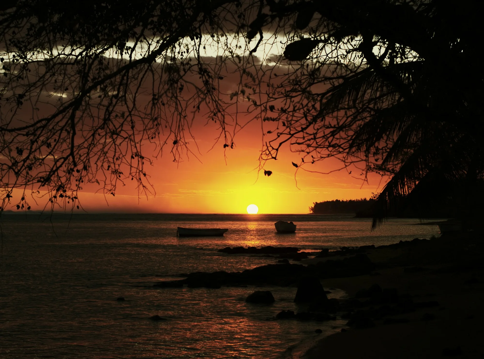 Boats on calm water at sunset in Mauritius