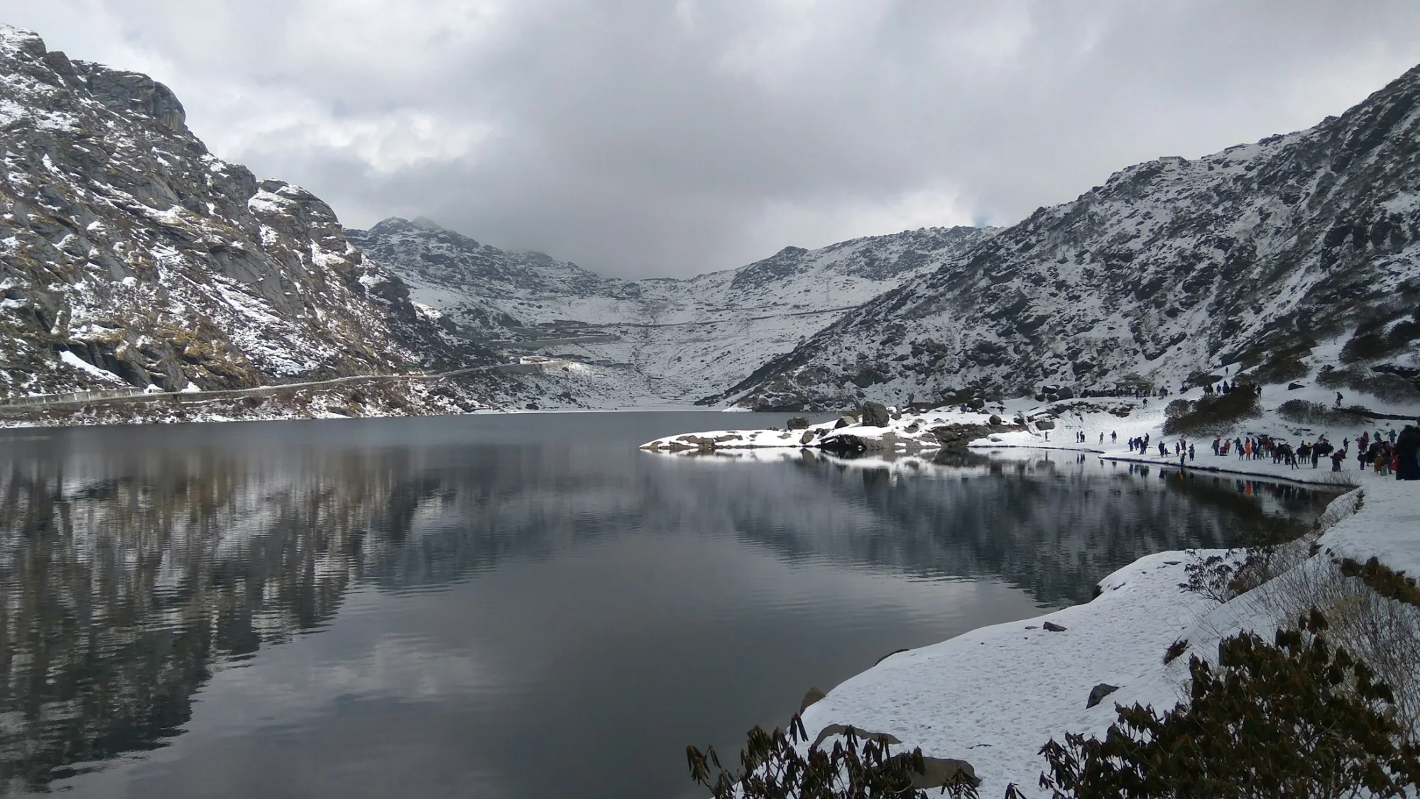 The glacial Tsomgo Lake ringed by snow-covered mountains in Sikkim