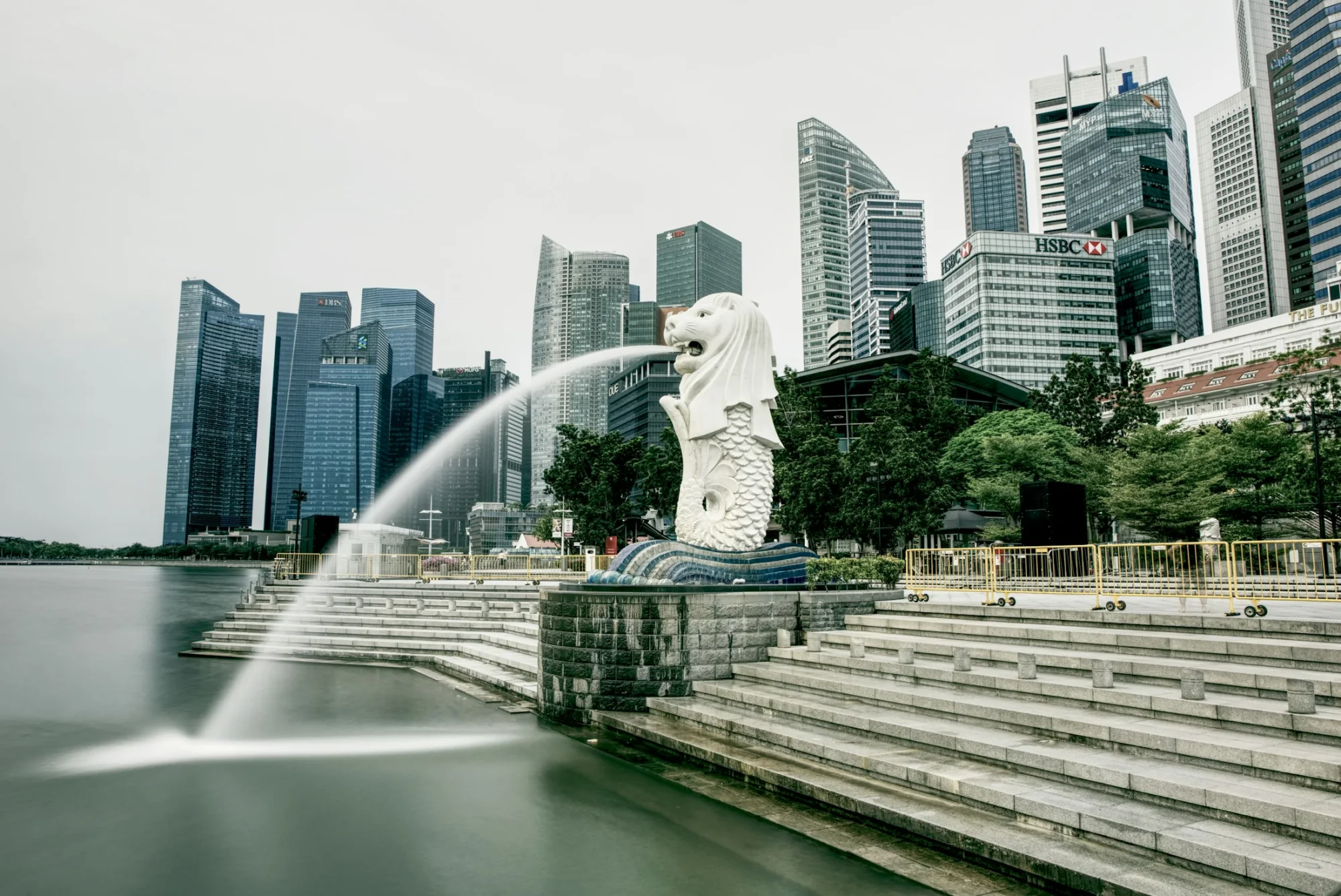 The Merlion statue spouting water with the Singapore skyline behind