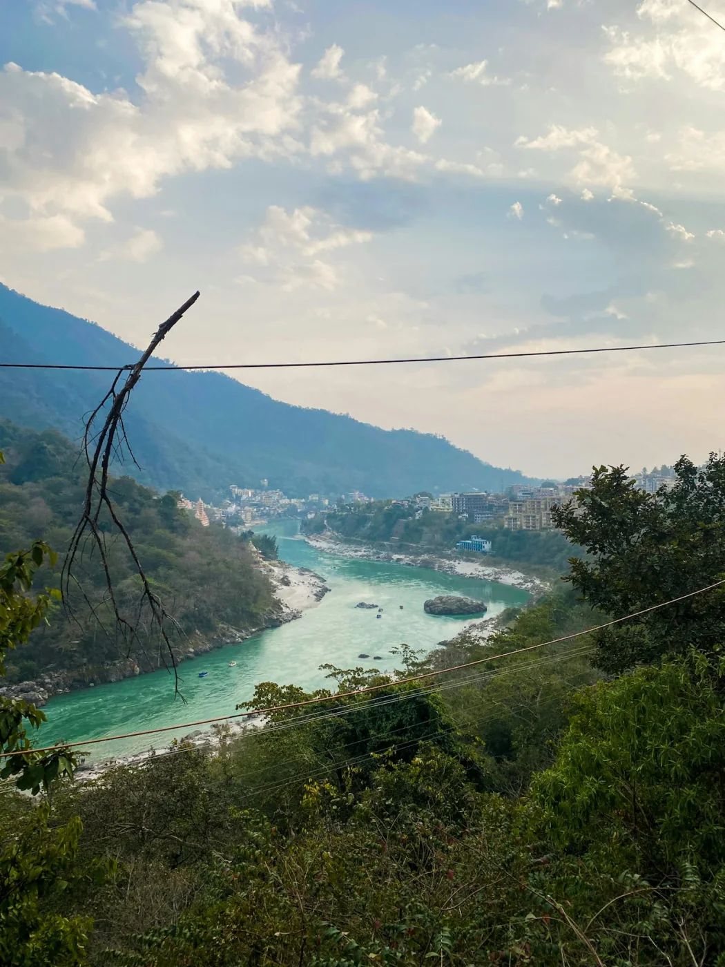 The Ganga flowing through a green Himalayan valley in Uttarakhand