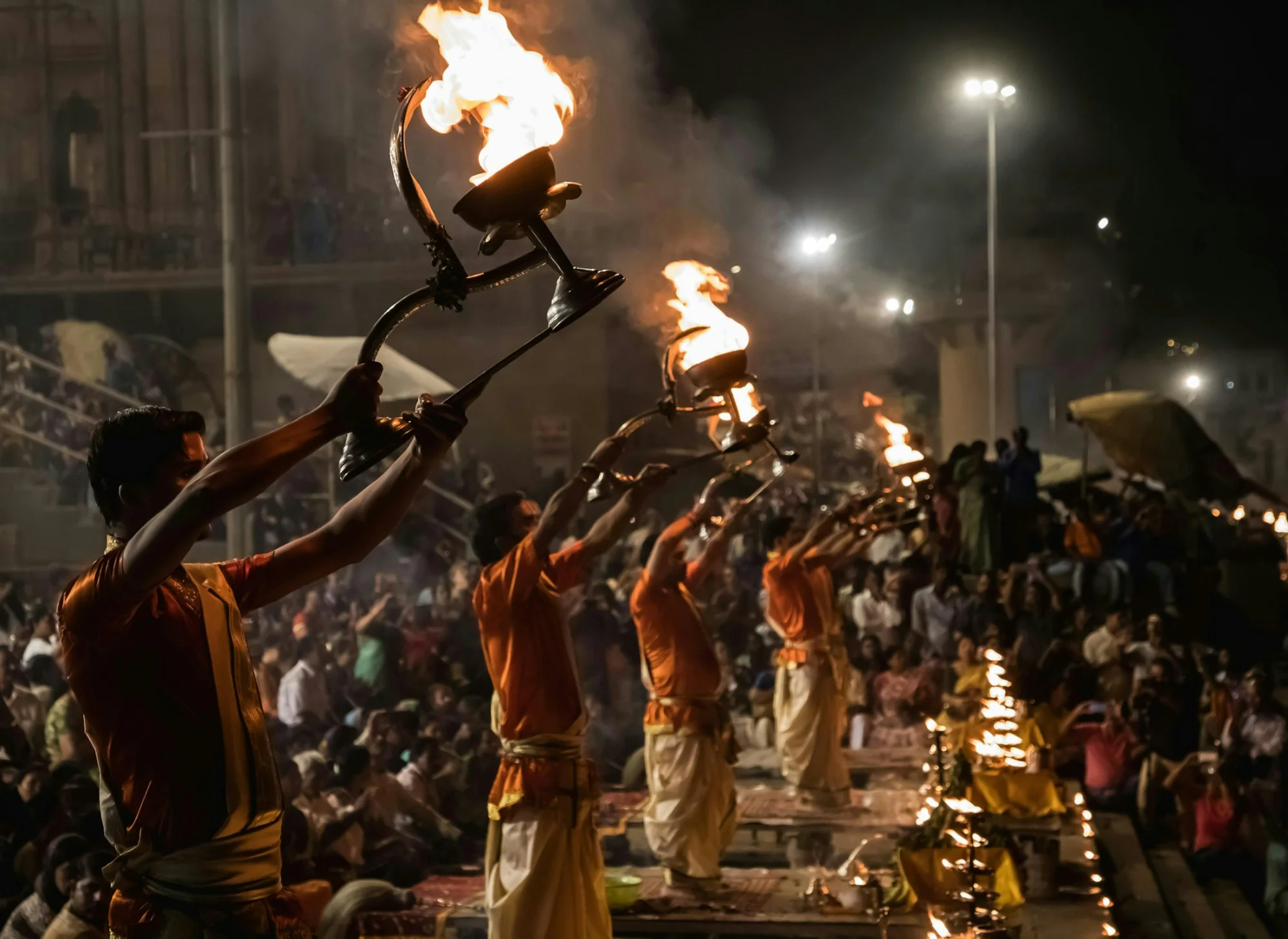 Priests performing the evening Ganga Aarti with fire lamps at Varanasi