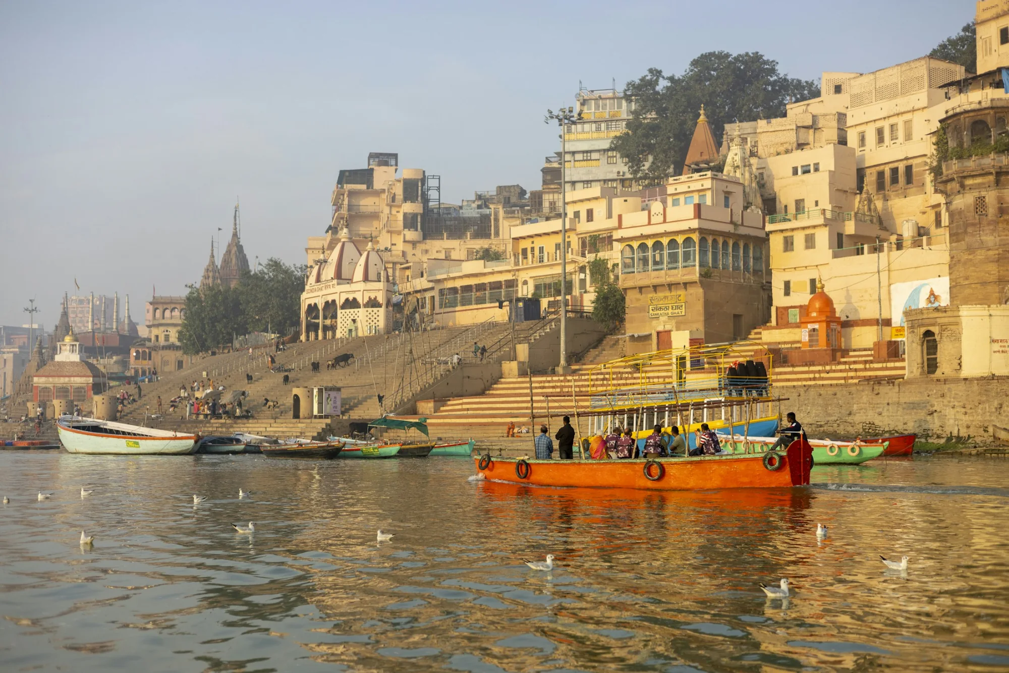 Boats moored along the historic stone ghats of Varanasi on the Ganges